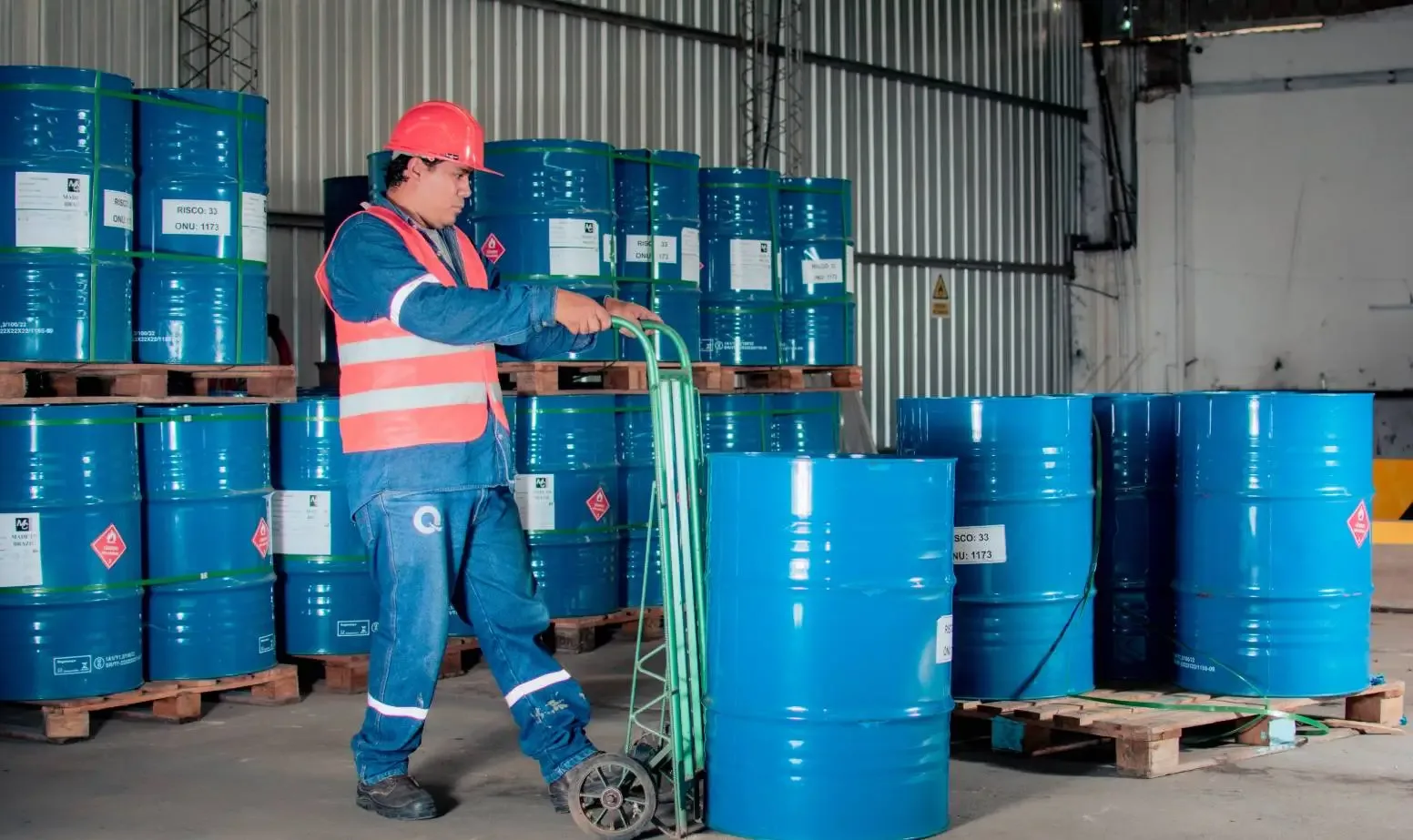 Warehouse operator walking along storage aisles while picking orders.